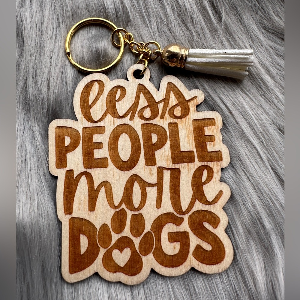 Handmade wood keychain with tassel: Less people more dogs.